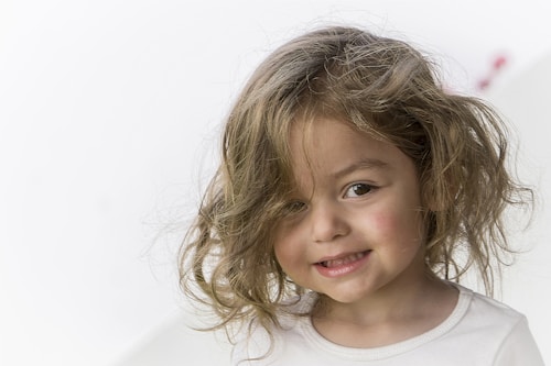 Toddler with a big smile during art time