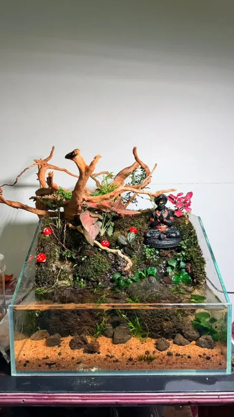 Paludarium under construction on the studio bench, with driftwood, moss and a water section